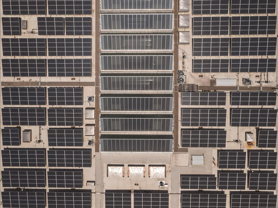 Aerial view of a large commercial rooftop solar installation, illustrative photograph