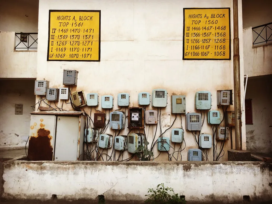 Electricity meters installed on a wall in India, illustrative photograph