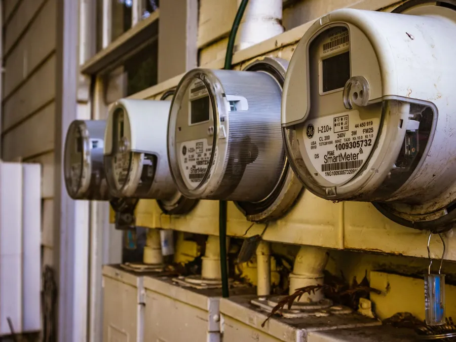 Electricity meters on a residential wall, illustrative photograph