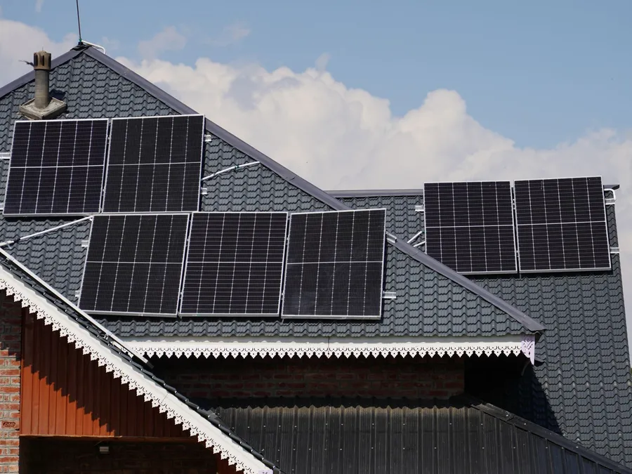 Rooftop solar panels on a residential building, illustrative photograph